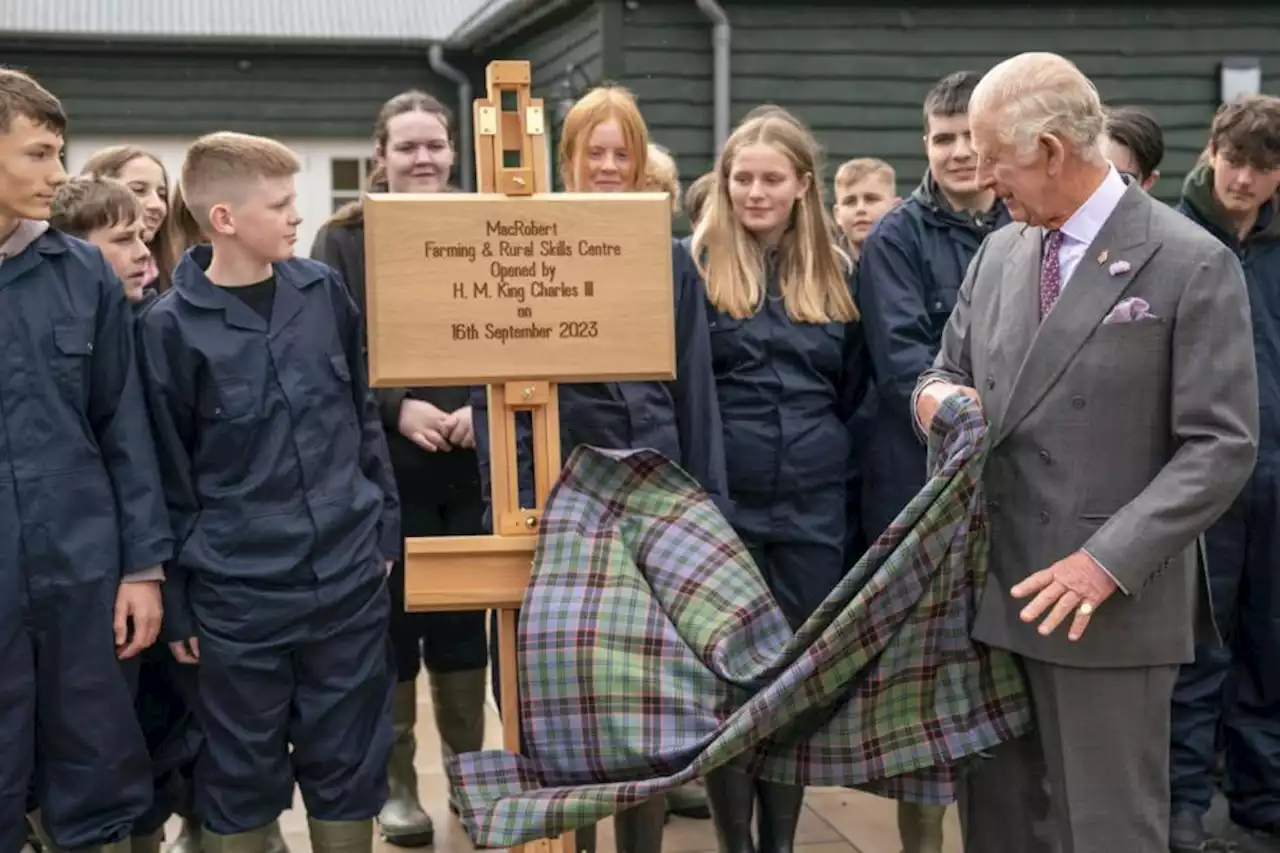 King meets pupils learning rural skills after helping to save estate