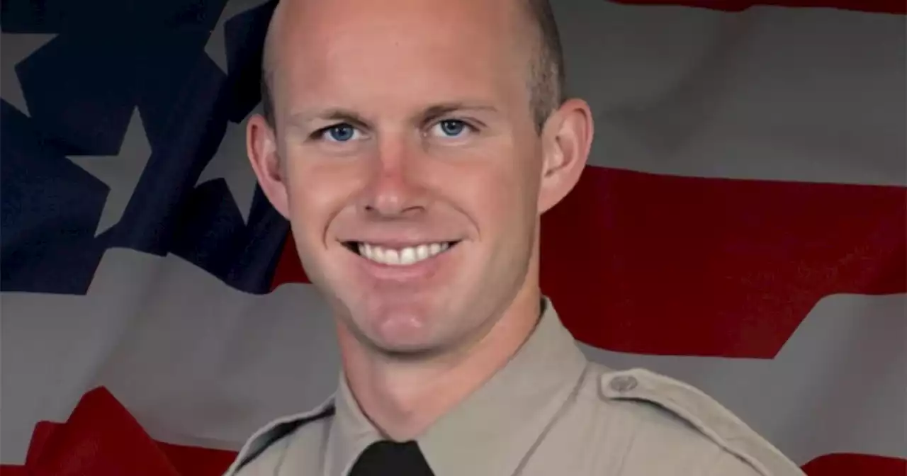 Los Angeles County sheriff's deputy shot dead in his patrol car