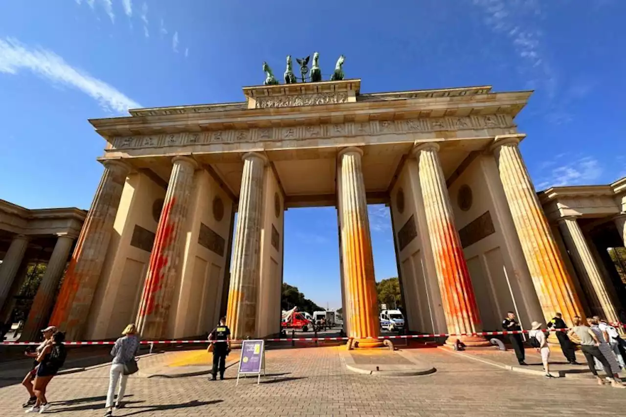 Climate activists spray Berlin’s Brandenburg Gate with orange paint