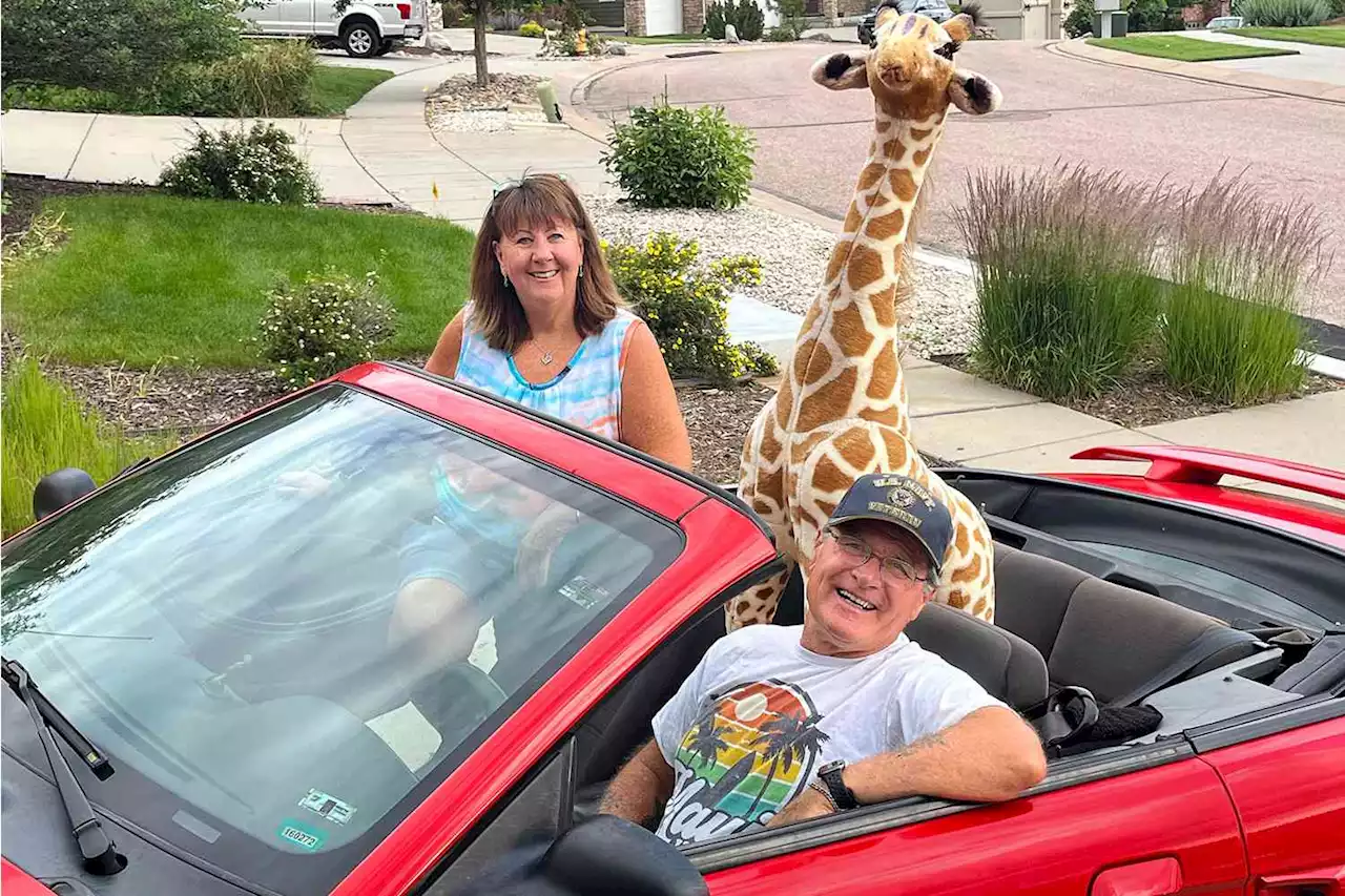 Couple Brings ‘So Much Joy’ by Driving a Stuffed Giraffe Around in Their Convertible