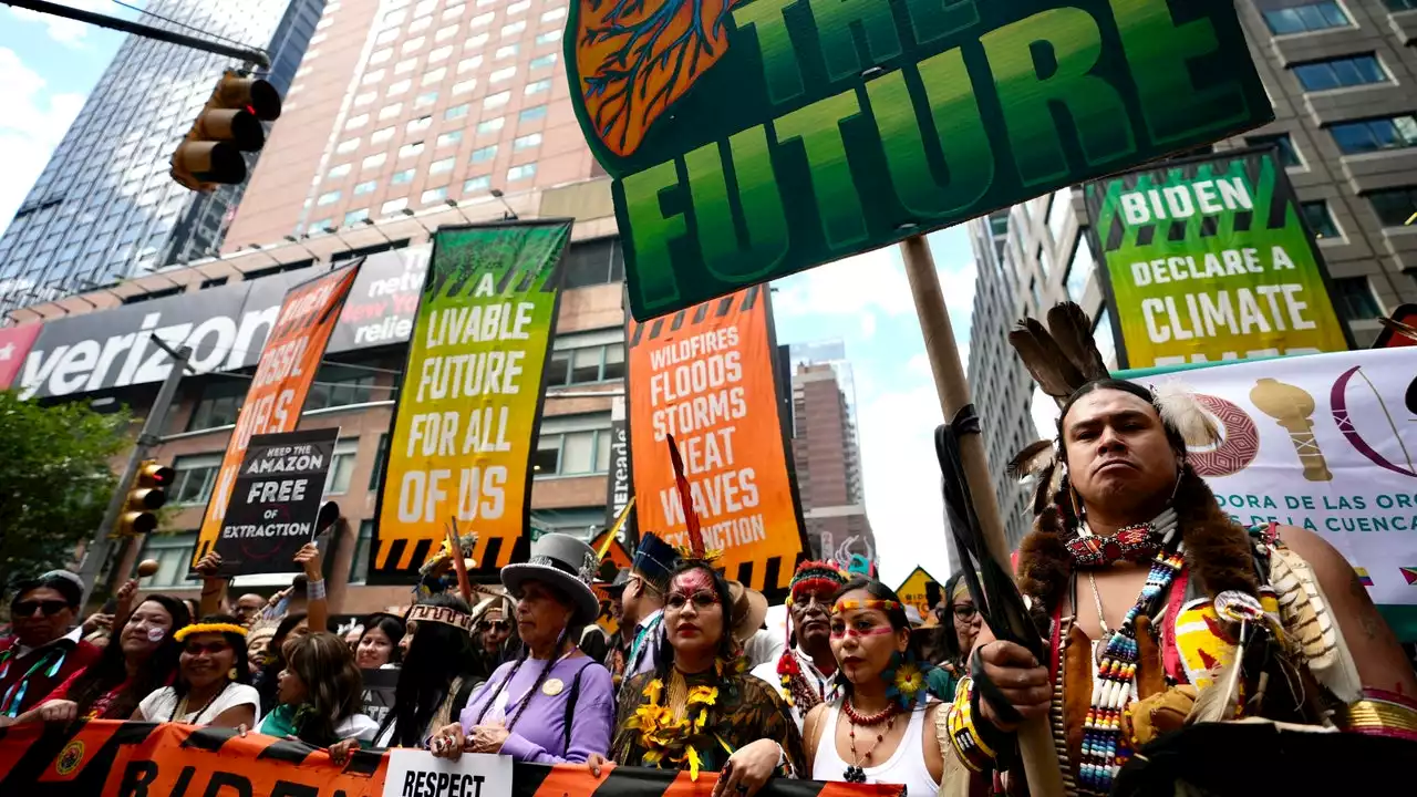 Tens of thousands march to kick off climate summit, demanding end to warming-causing fossil fuels