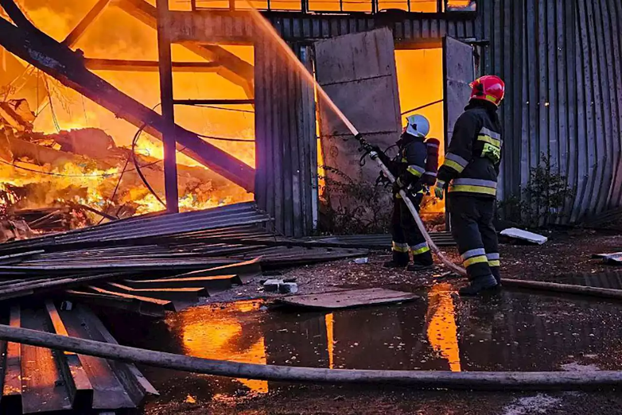 Russian attacks on Ukraine kill at least two people, set Lviv warehouses ablaze