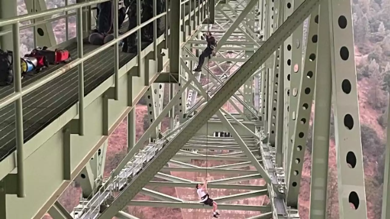 Teen found dangling from California's highest bridge rescued