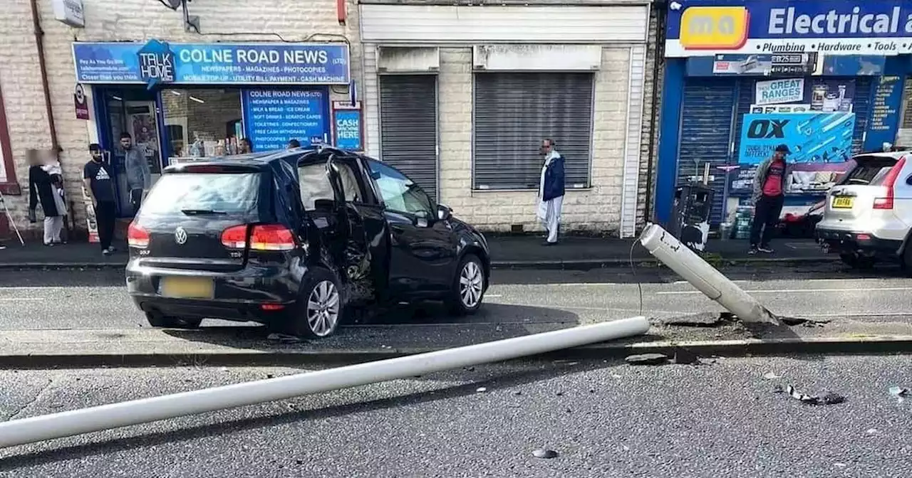 Aftermath of crash that left cars smashed and lamppost snapped off