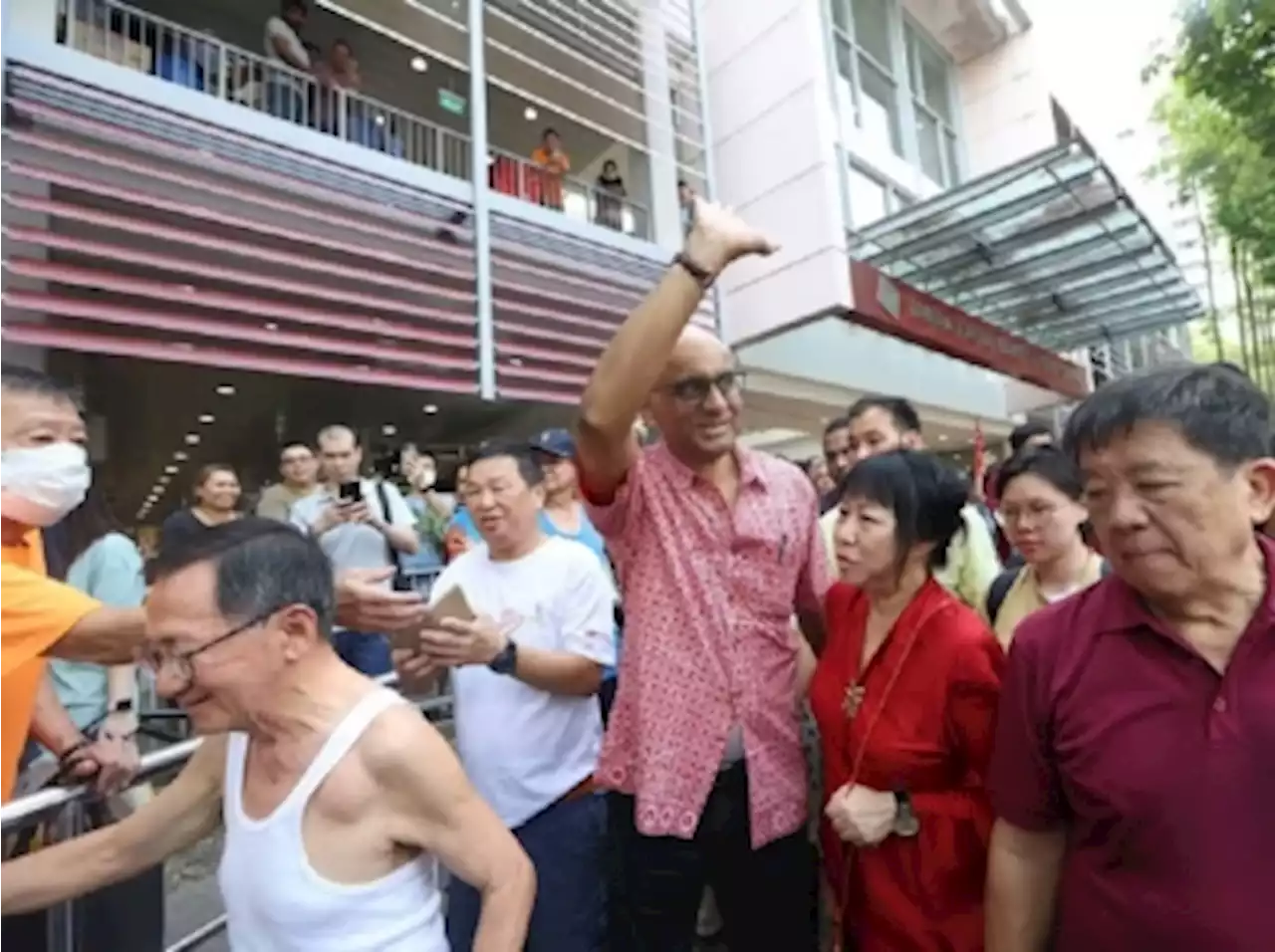 In Singapore, supporters greet President-elect Tharman on victory parade with cheers, handshakes and pineapples