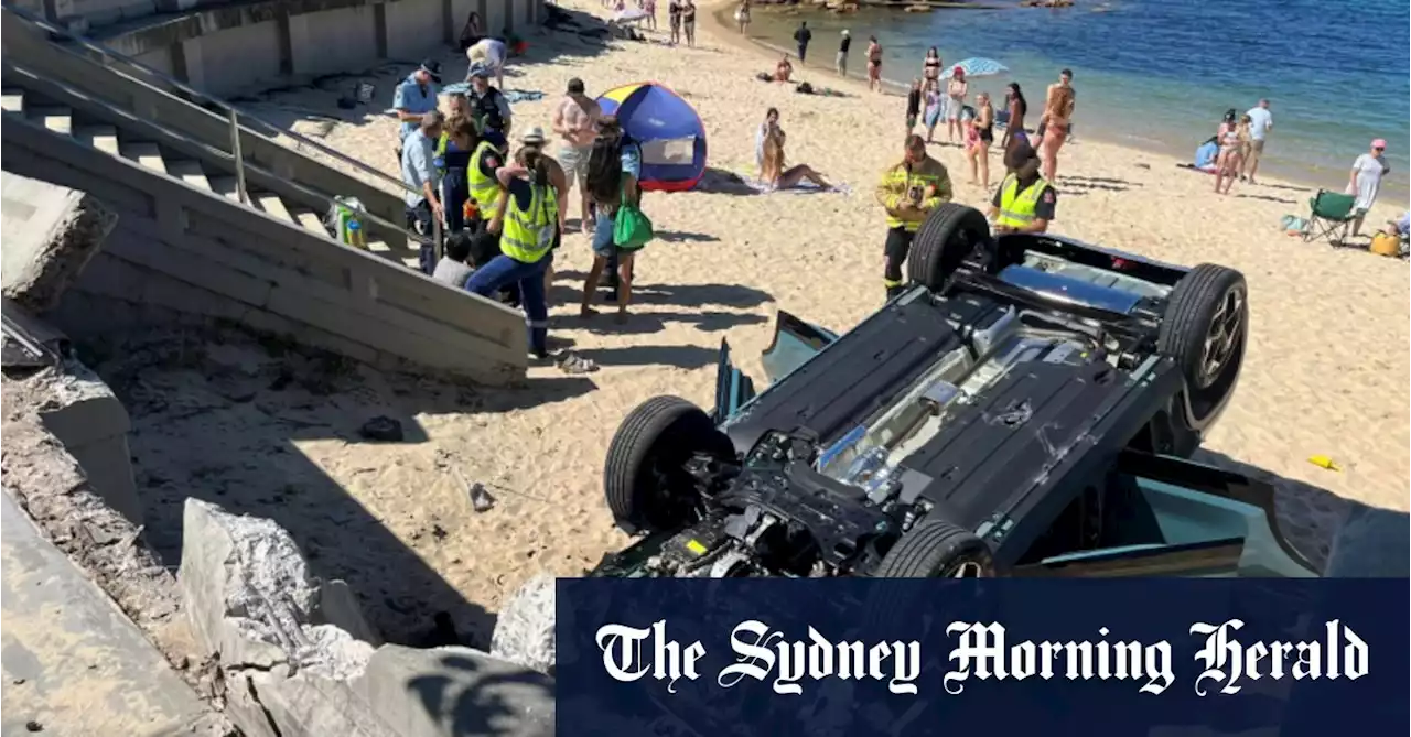 ‘Very scary’: Car smashes through north shore beach wall, flips onto sand