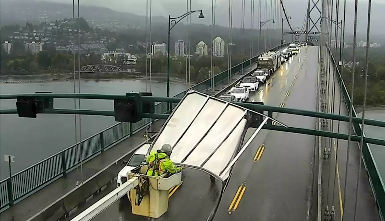 Large metal object wraps around overhead section of Lions Gate Bridge