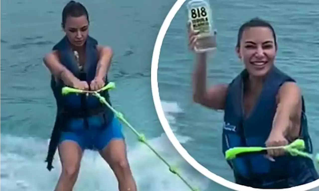 Kim Kardashian wipes out on wakeboard while holding Kendall's tequila