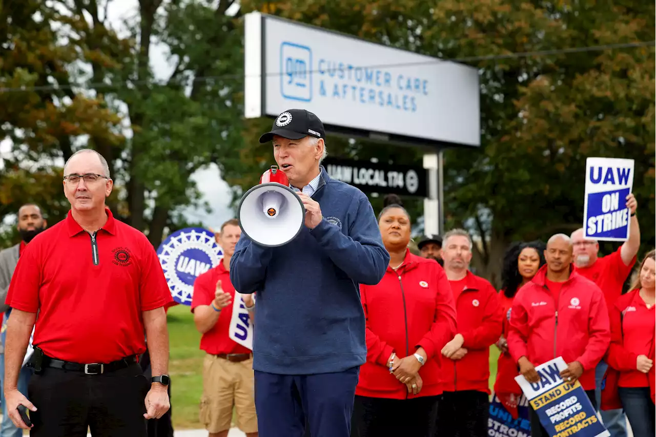 Biden stands with striking UAW autoworkers in Michigan, supports big pay raise