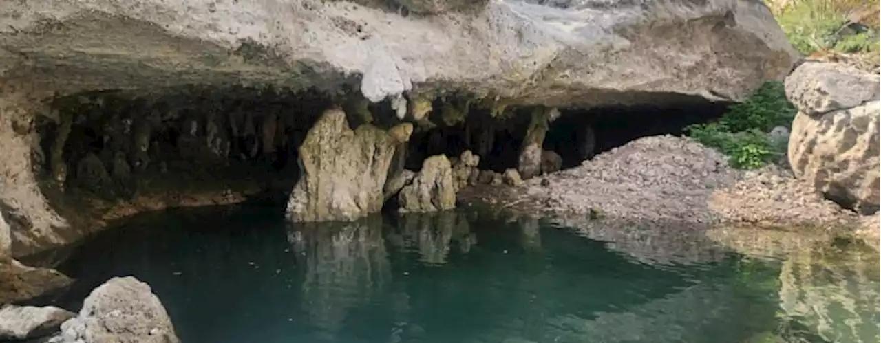 See photos inside cave previously hidden underwater at Canyon Lake; remnants of old town also revealed