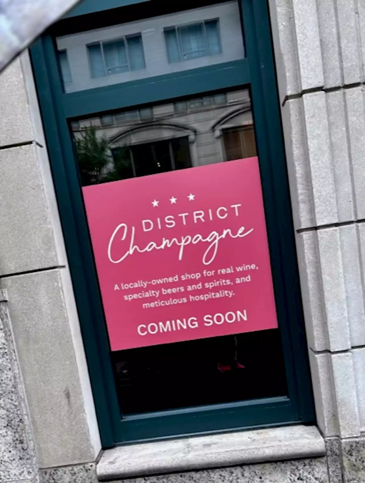 District Champagne coming soon signage up in West End