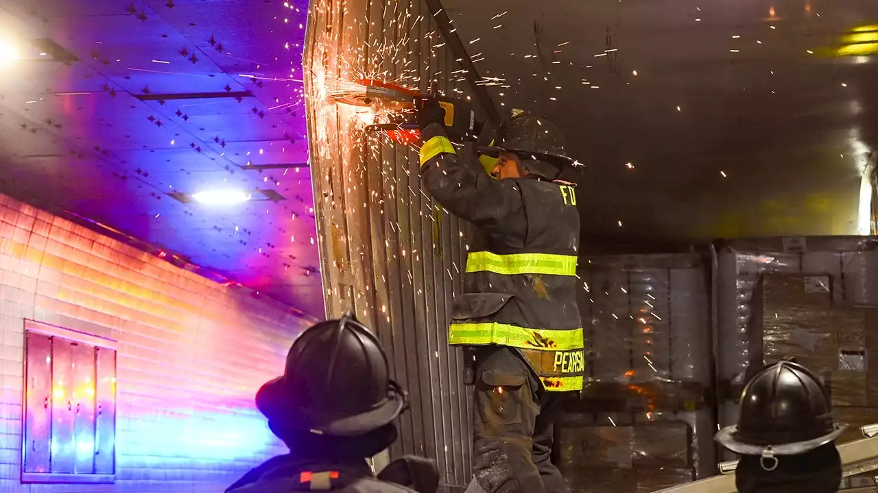 NYC firefighters seen cutting apart truck that got wedged in tunnel, causing traffic nightmare