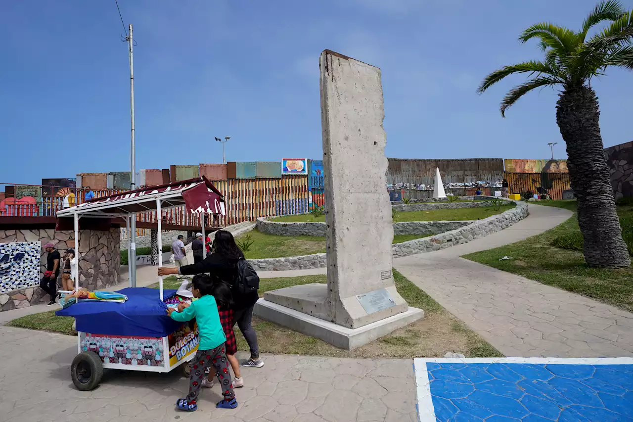 Mexico installs Berlin Wall fragment near US border as Biden adds barriers