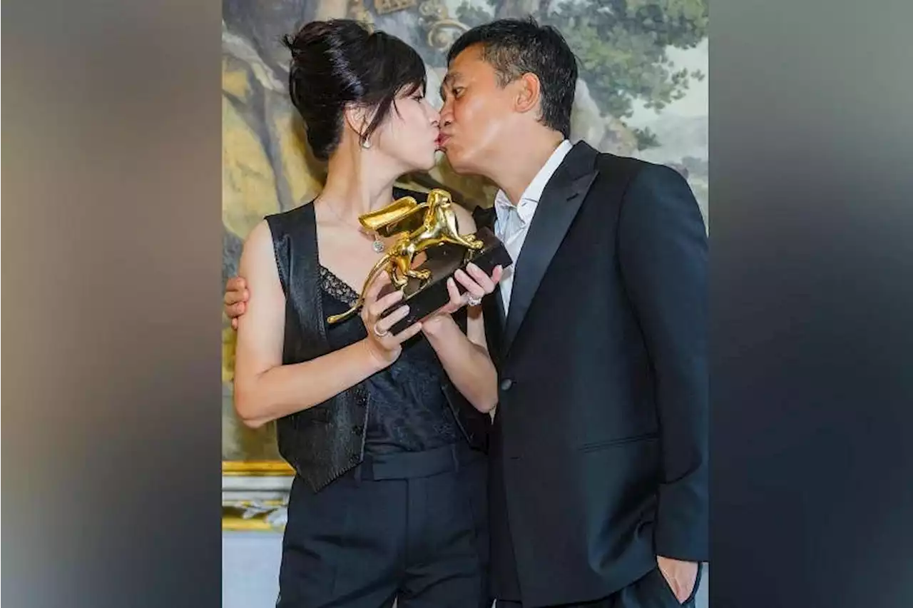 Carina Lau and Tony Leung Chiu-wai celebrate his lifetime achievement award with a kiss in Venice