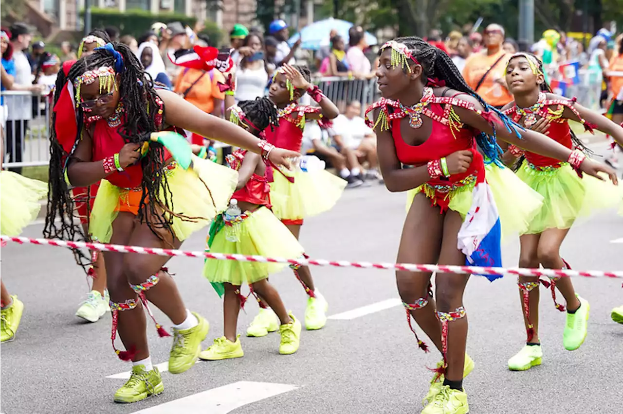 West Indian American Day Parade steps off with steel bands, colorful costumes, stilt walkers