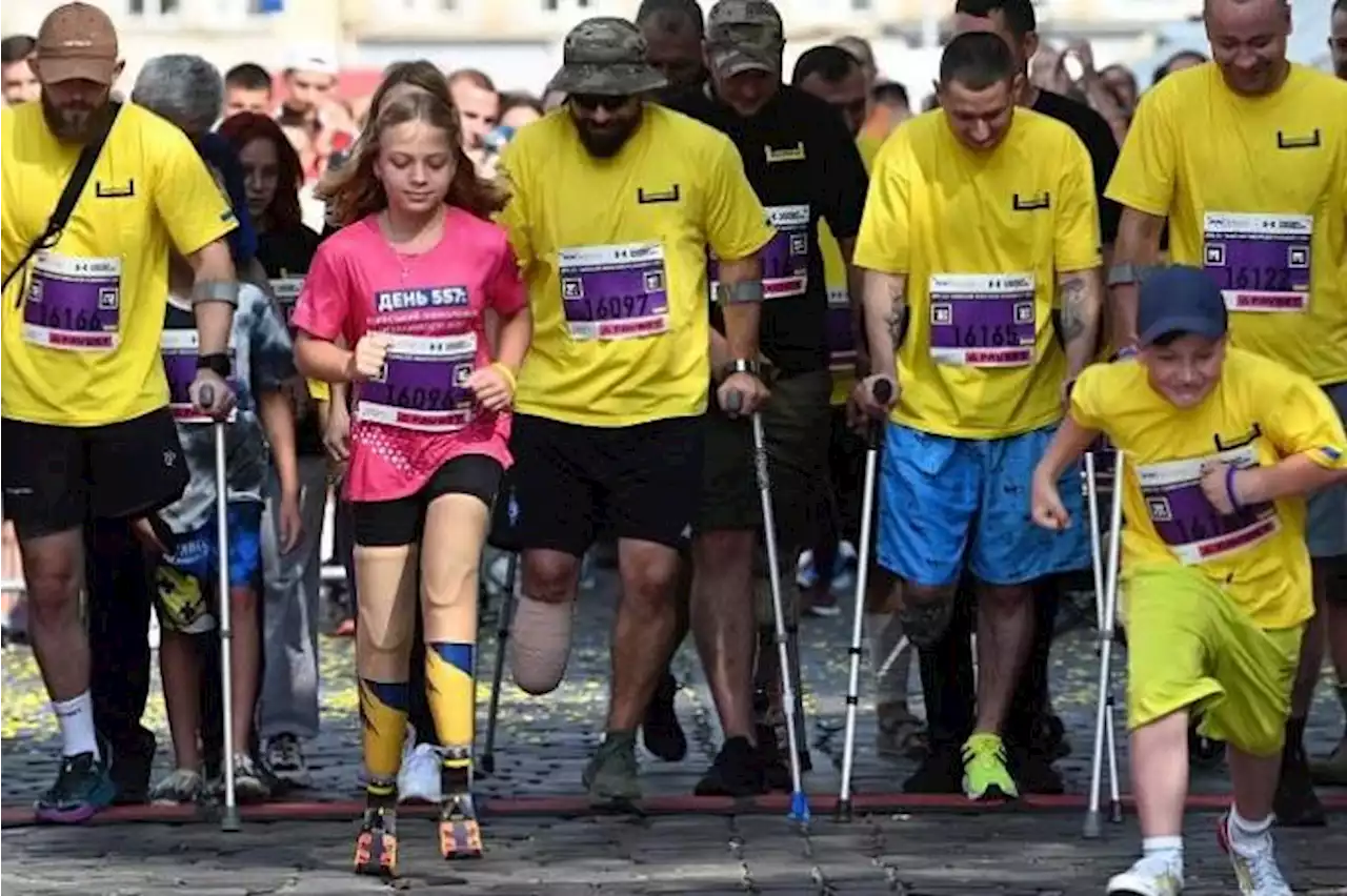 Girl, 12, who lost legs in Russian missile attack, runs at Ukraine city half-marathon