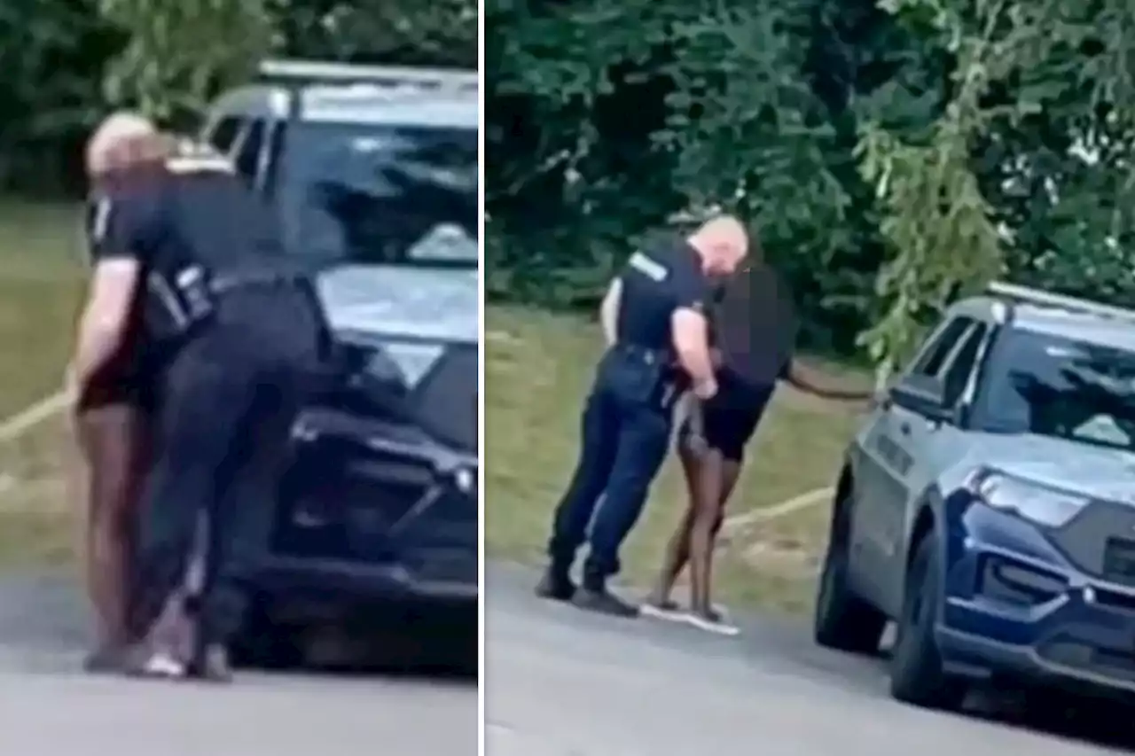 Maryland cop caught kissing scantily clad woman before climbing into back of squad car