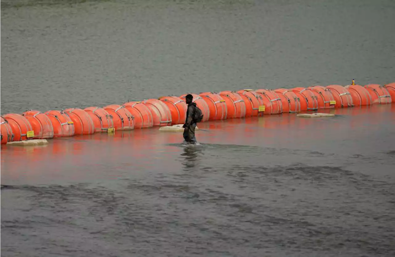 Judge orders Texas to move a large floating barrier to the riverbank of the Rio Grande by Sept. 15