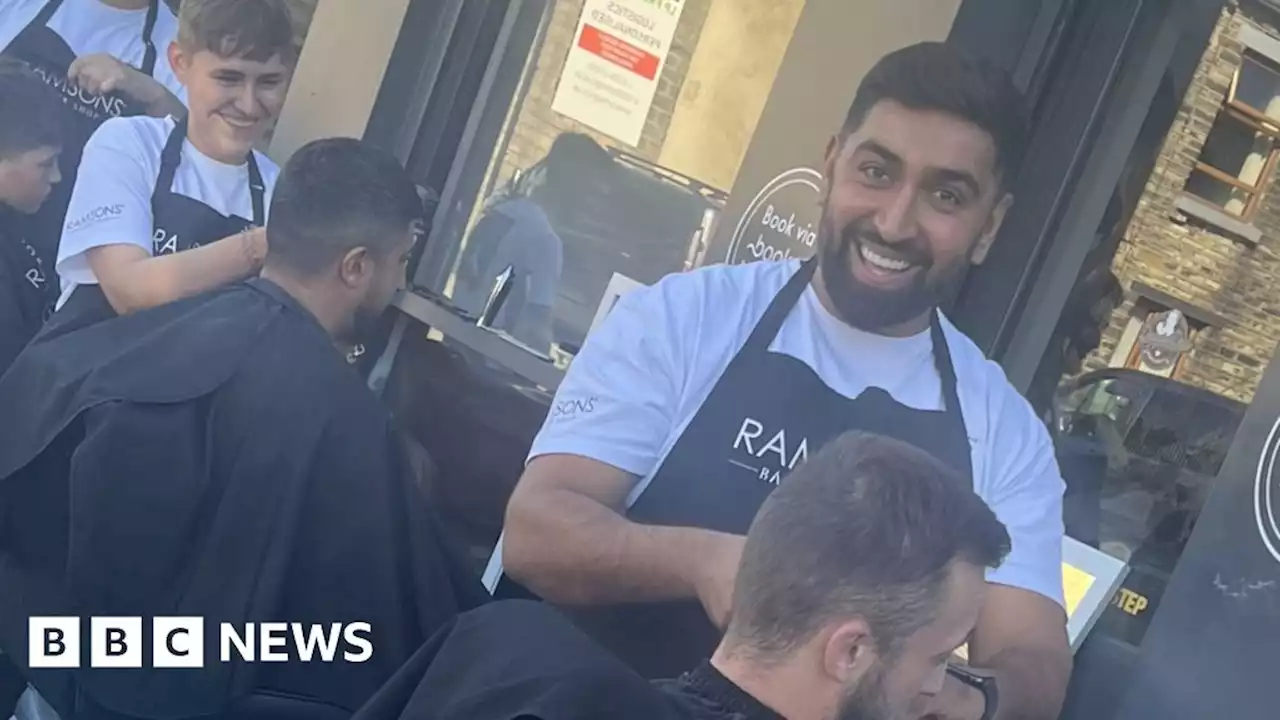 Barbers take their work outside during power cut