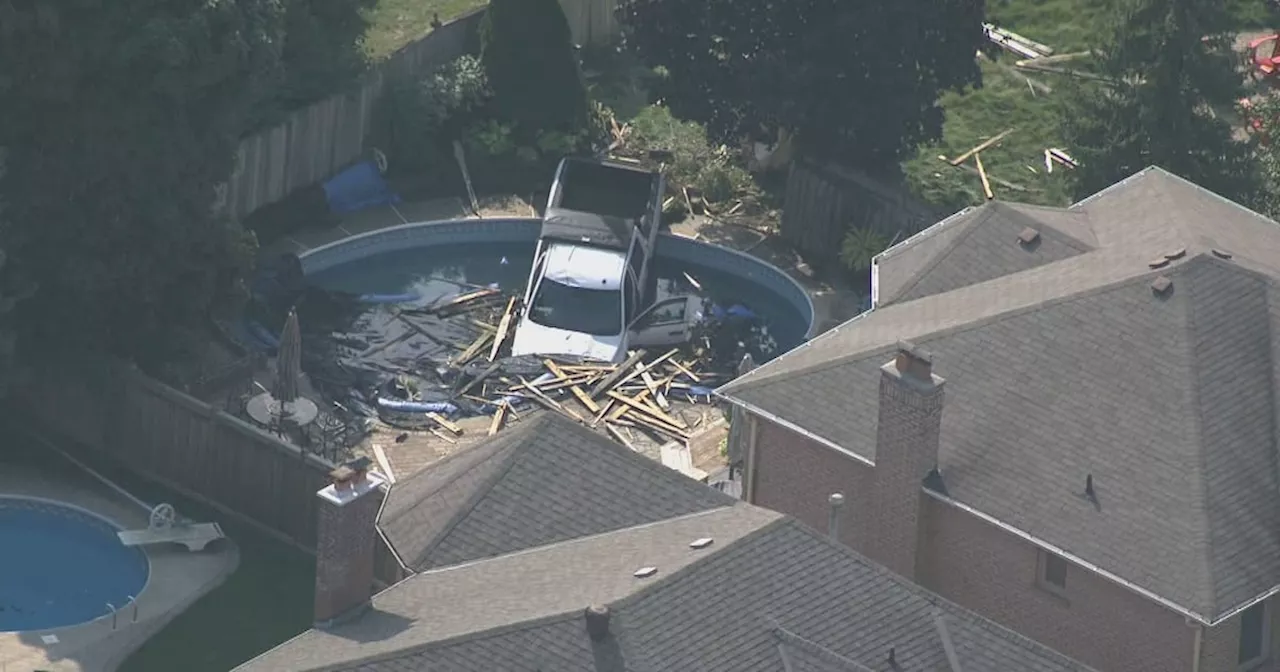 Pedestrian in hospital after truck crashes through fence in Whitby, lands in swimming pool