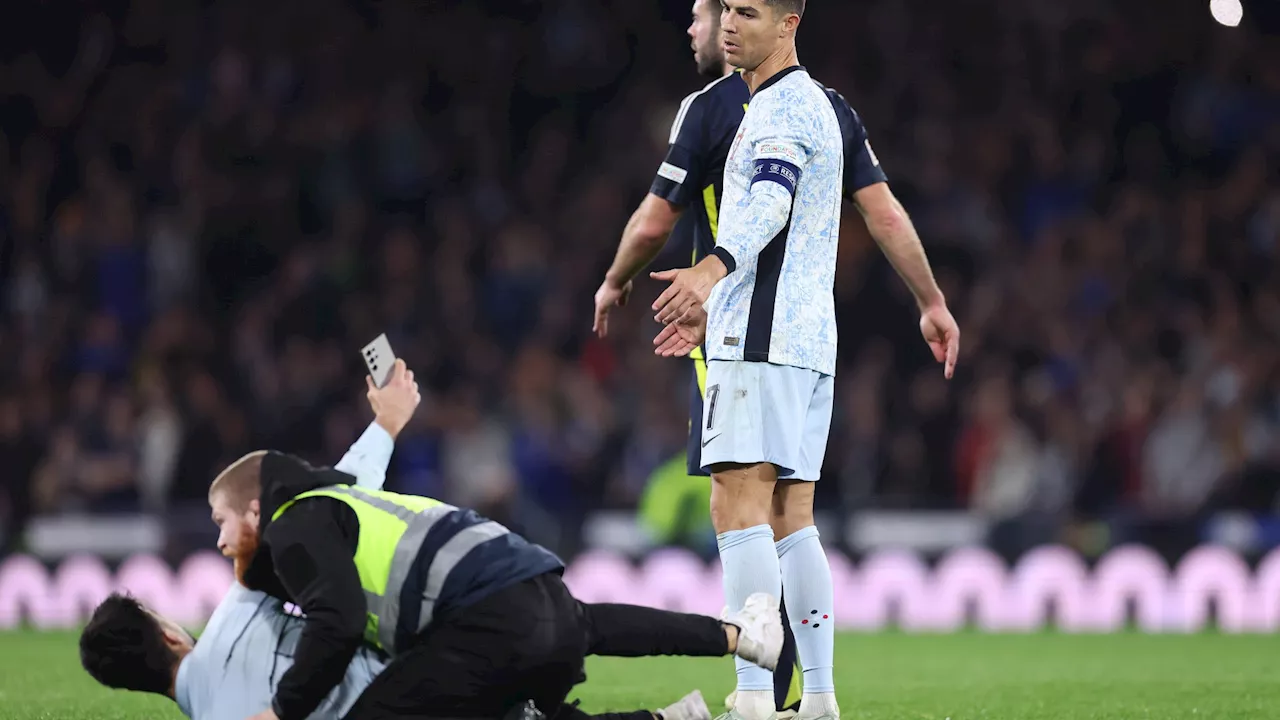 Cristiano Ronaldo swears at referee and was inches away from pitch invader at Scotland clash...