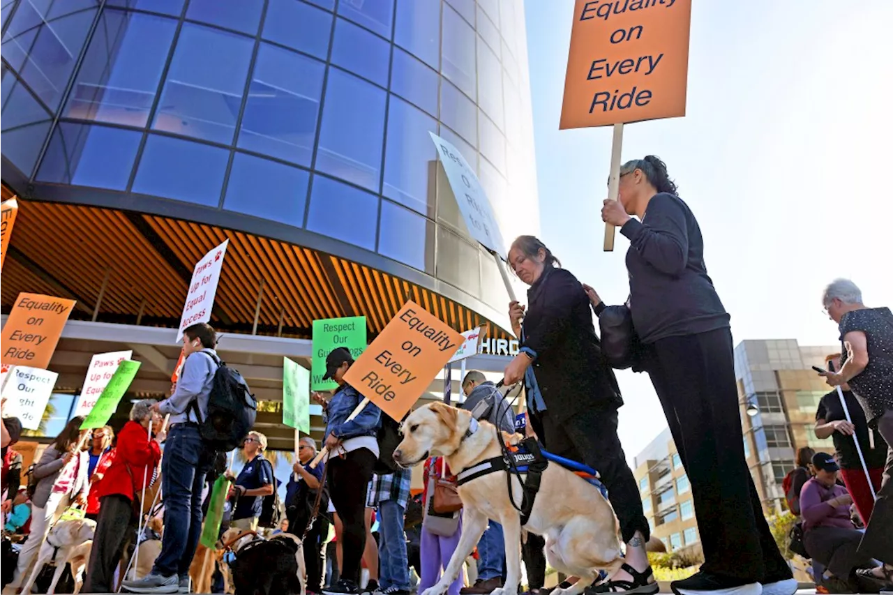 People with blindness and their allies rally outside Uber and Lyft over ride denials