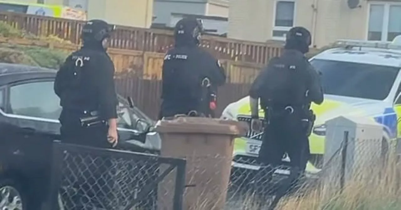 Armed police storm Scots street after 'machete wielding man kicks down door'