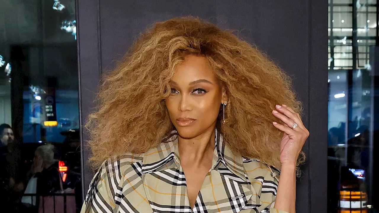 Tyra Banks rocks a trench coat at Burberry 57th Street Store reopening