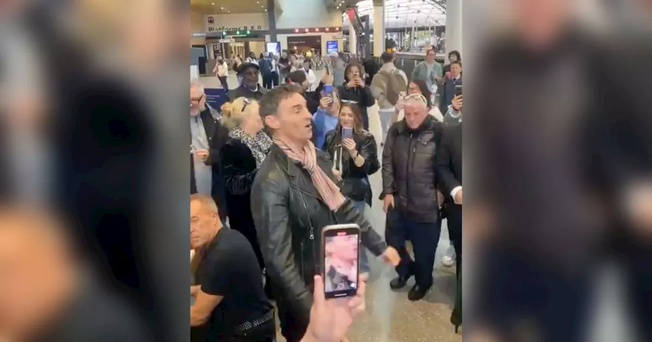 Marti Pellow performs at Queen Street station as surprised commuters watch on