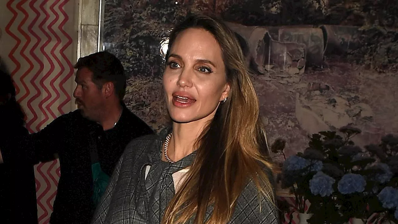 Angelina Jolie looks elegant in boots and a cape following Maria panel discussion in London