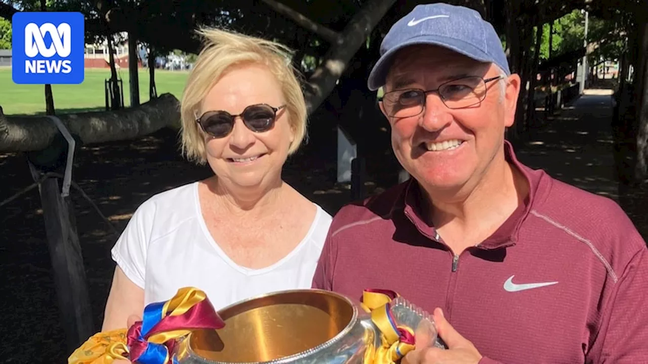 Lions coach Chris Fagan takes AFL premiership cup out for a walk in suburban Brisbane