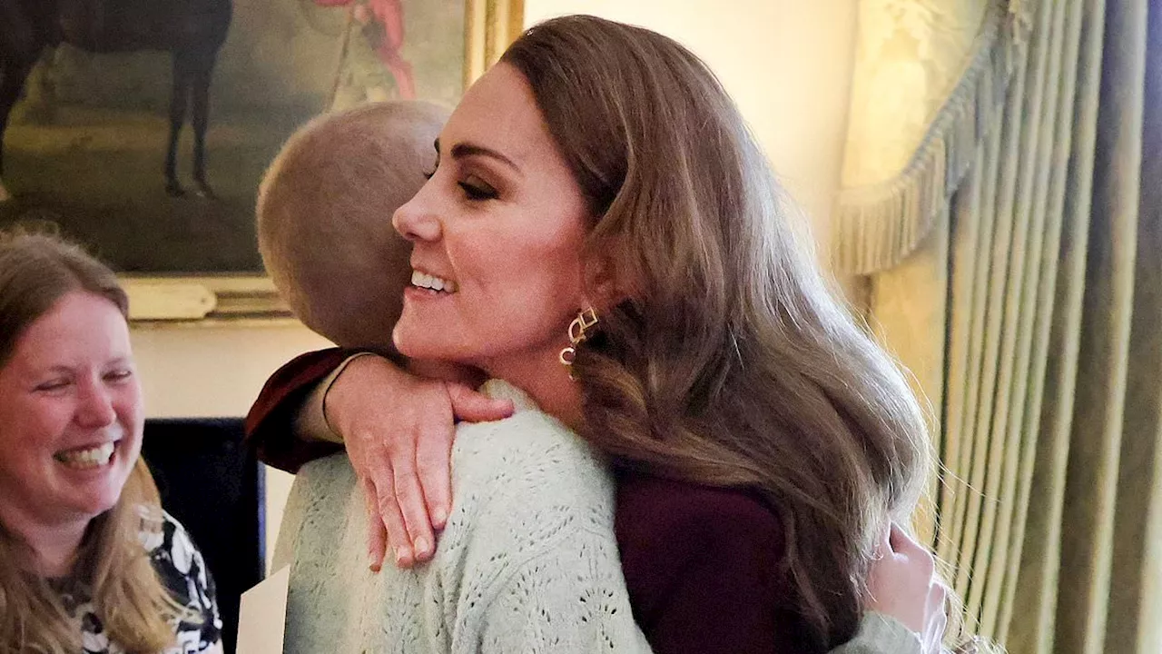 The hug that says 'I'm with you': Kate Middleton embraces young cancer-stricken photographer at...