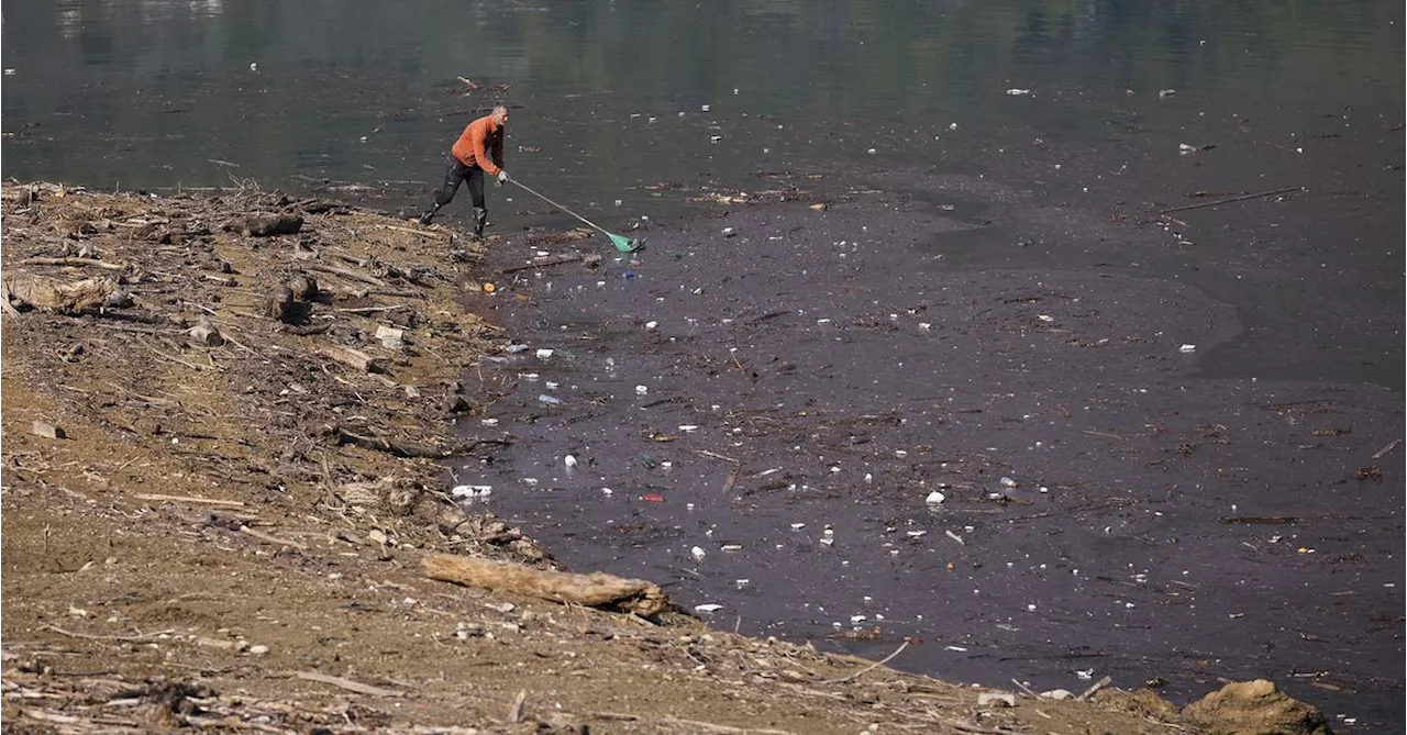 Residents and activists in central Bosnia clean up a lake after massive floods