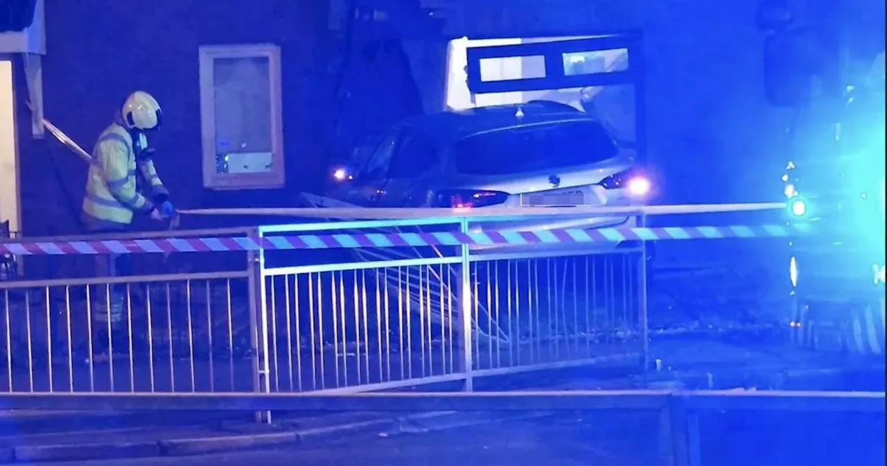 Car crashes into Glasgow house as police arrest two men