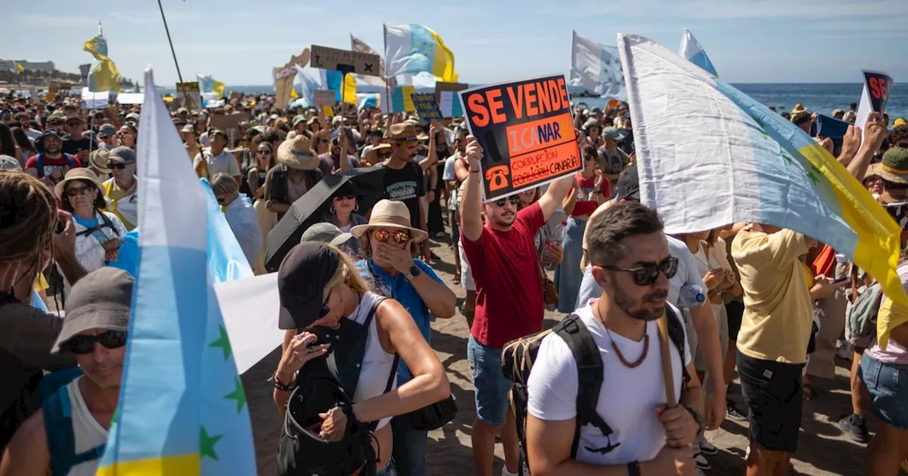 Anti-tourist protesters storm beach and surround sunbathing holidaymakers