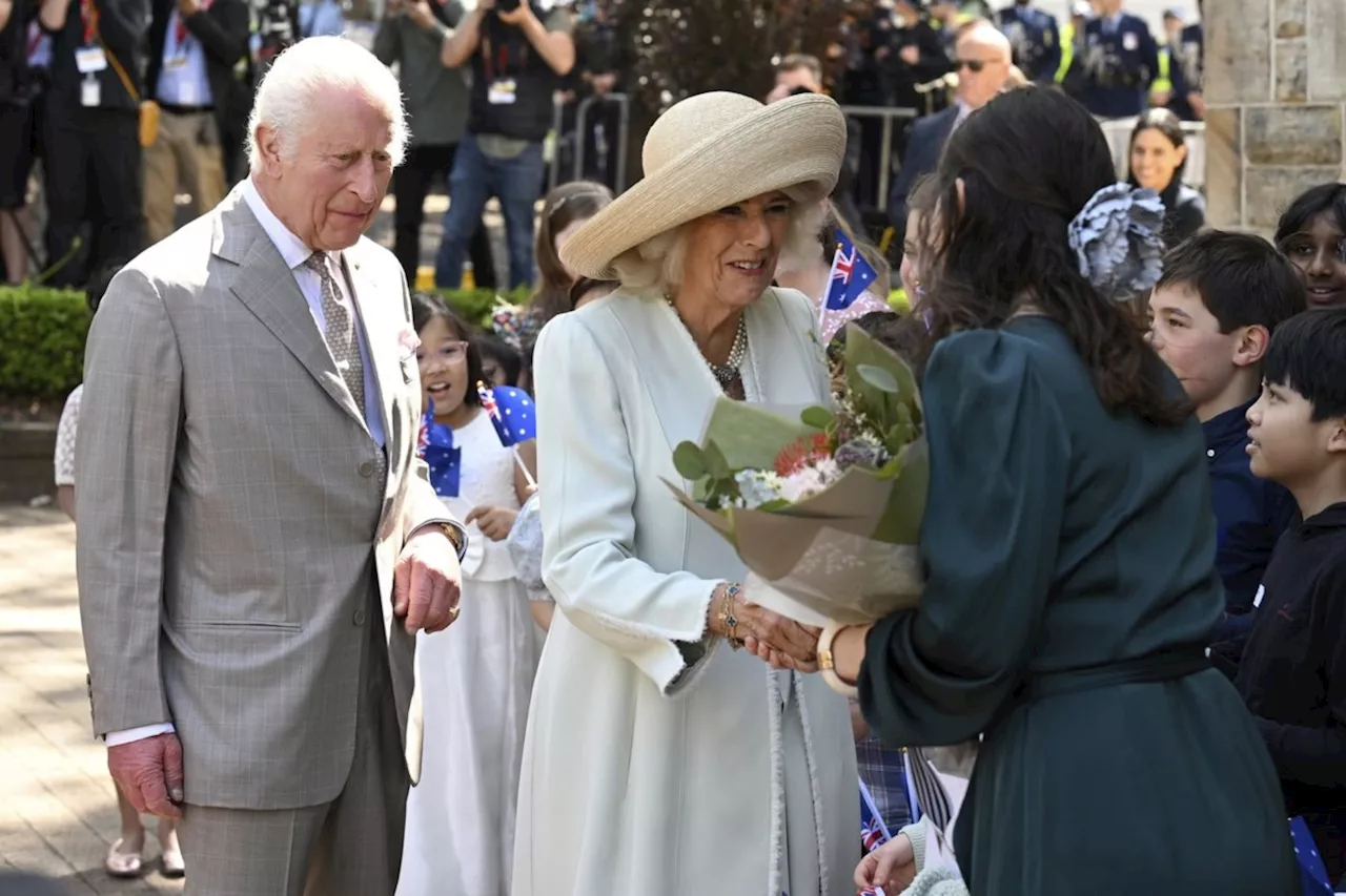 Children greet King Charles and Queen Camilla outside a Sydney church