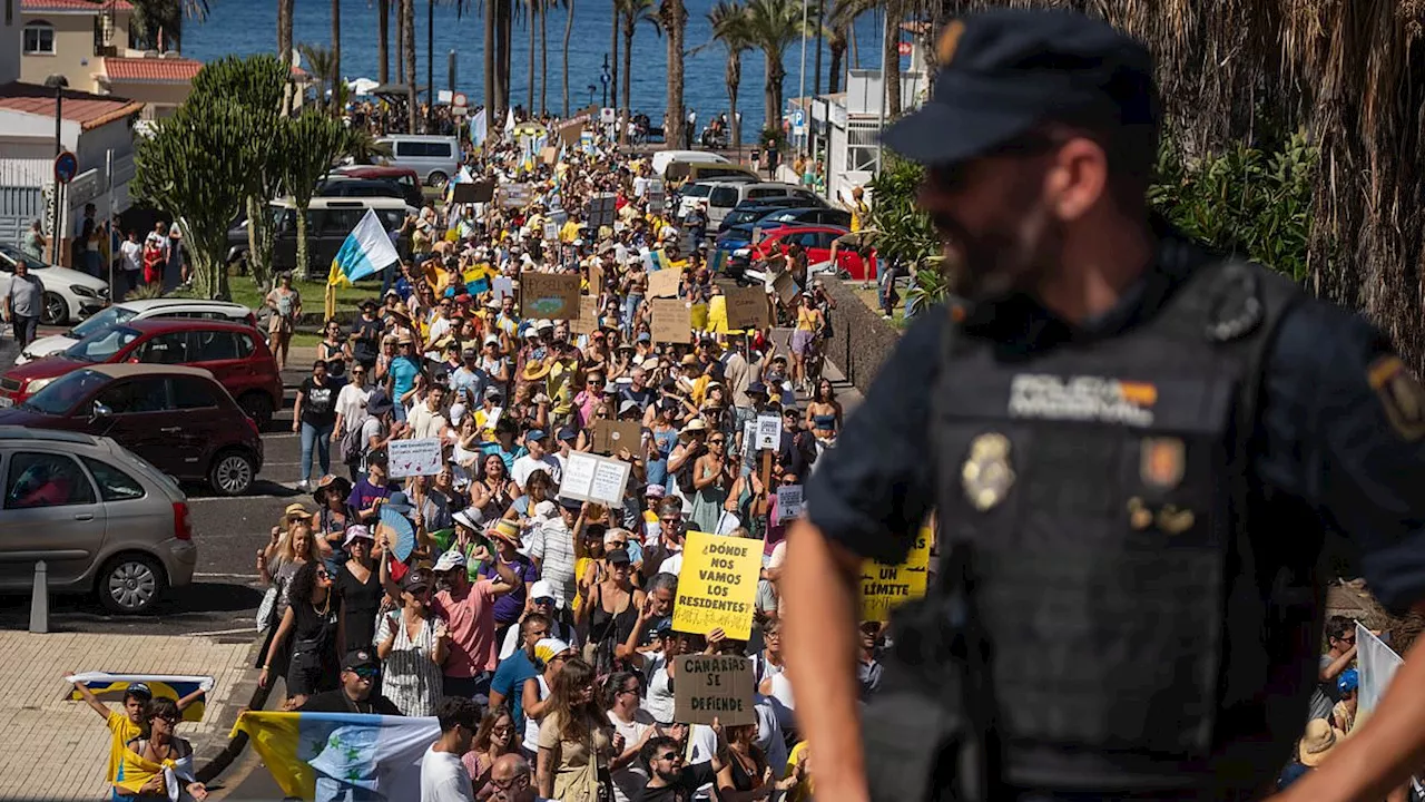 Anti-tourism protesters are branded 'd***heads' by furious Tenerife locals after huge mob surrounded...