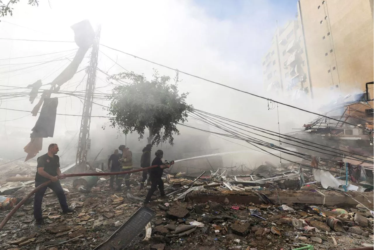 Lebanese flee as blasts hit Beirut, Israel warns of strikes on Hezbollah finance arm