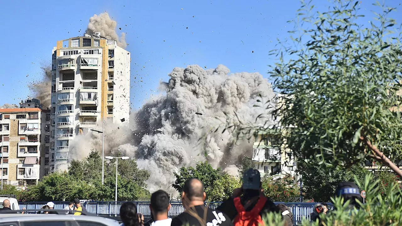 Astonishing moment Lebanese tower block crumples and disappears in seconds after being hit by...