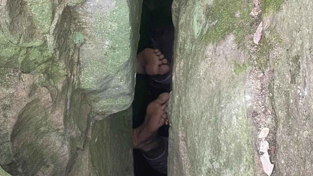 Moment hiker is found UPSIDE DOWN between two rocks in Australian outback after getting trapped trying to...