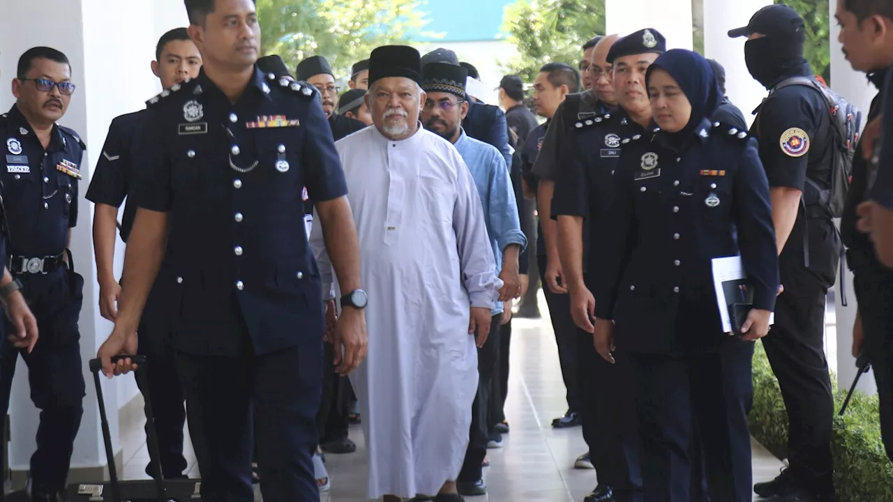 Malaysia charges 22 members of an Islamic business group, including its CEO, for organized crime