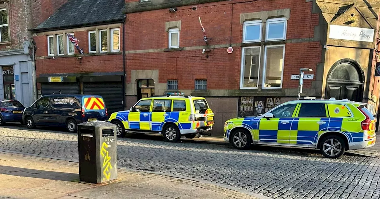 Police and CSI teams swoop on town centre street and find shotgun and bullets