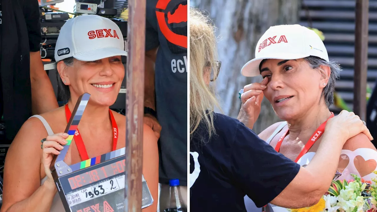 Gloria Pires grava na praia, se emociona com fãs e recebe flores