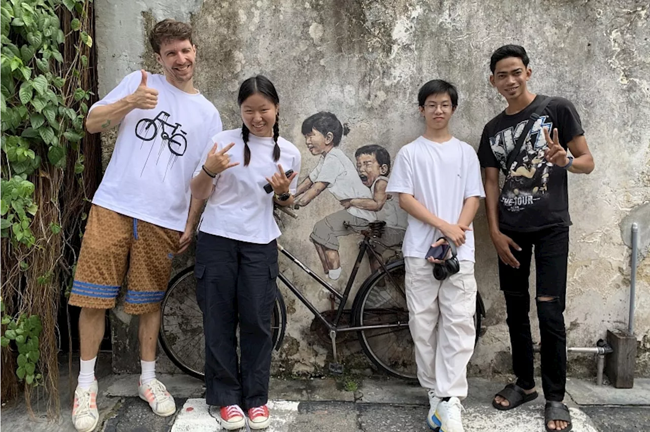 Now grown up, children who inspired Penang’s iconic murals 12 years ago reunite with artist