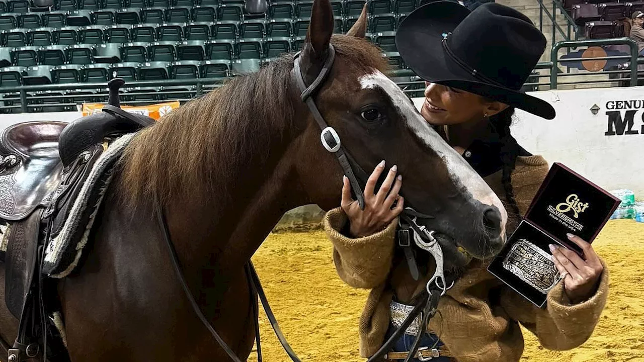 Bella Hadid proudly shows off first champion buckle while posing with her horse Metallic Tito