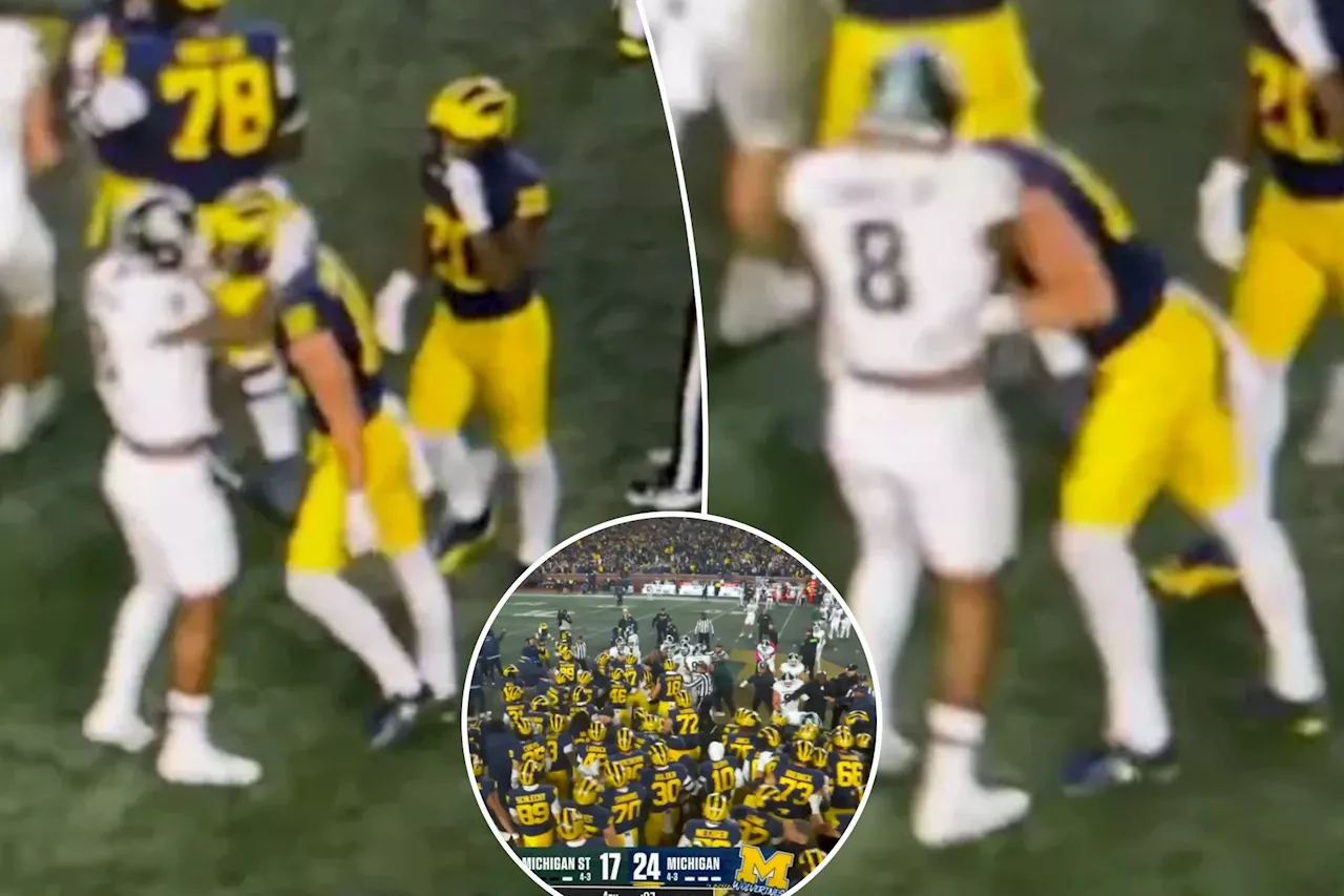 Punches thrown as Michigan, Michigan State sidelines clear in wild scene