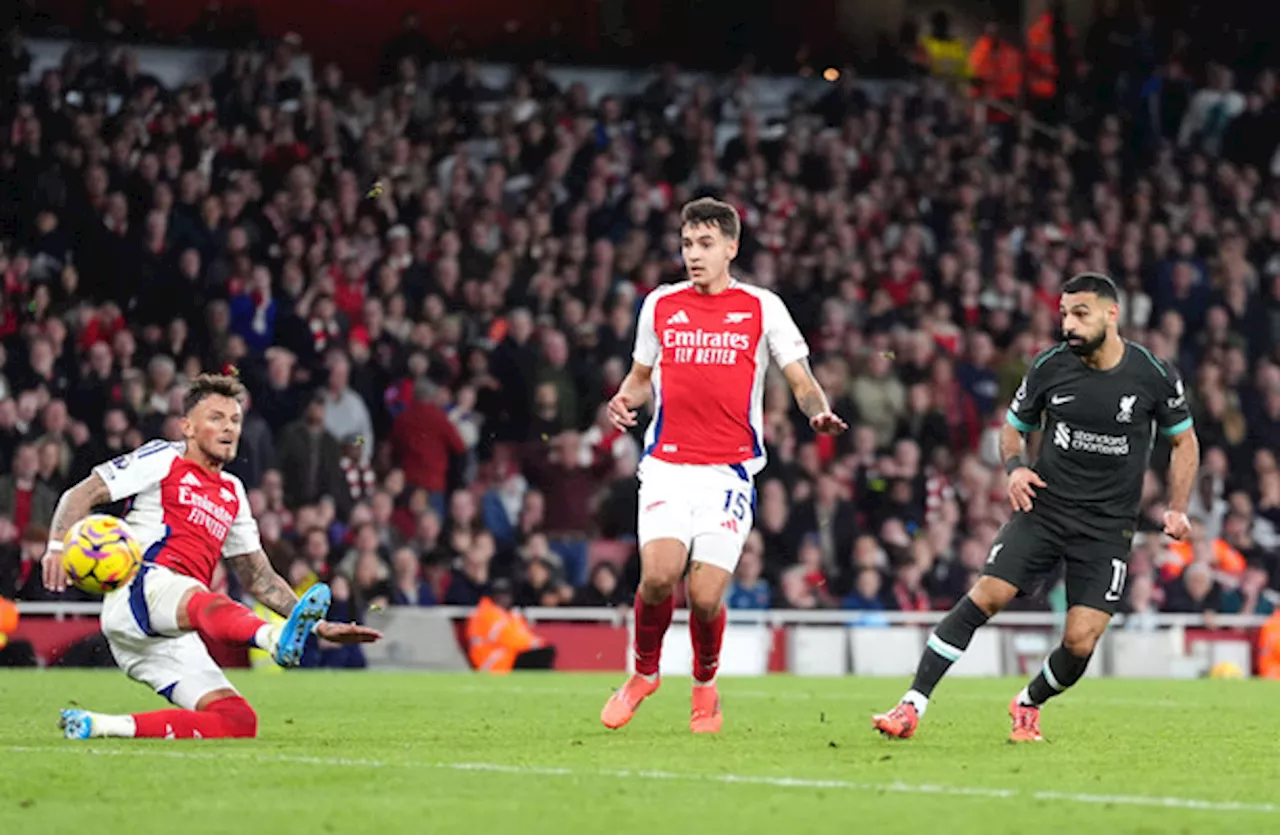 Liverpool fight back twice at Arsenal but stay second in table