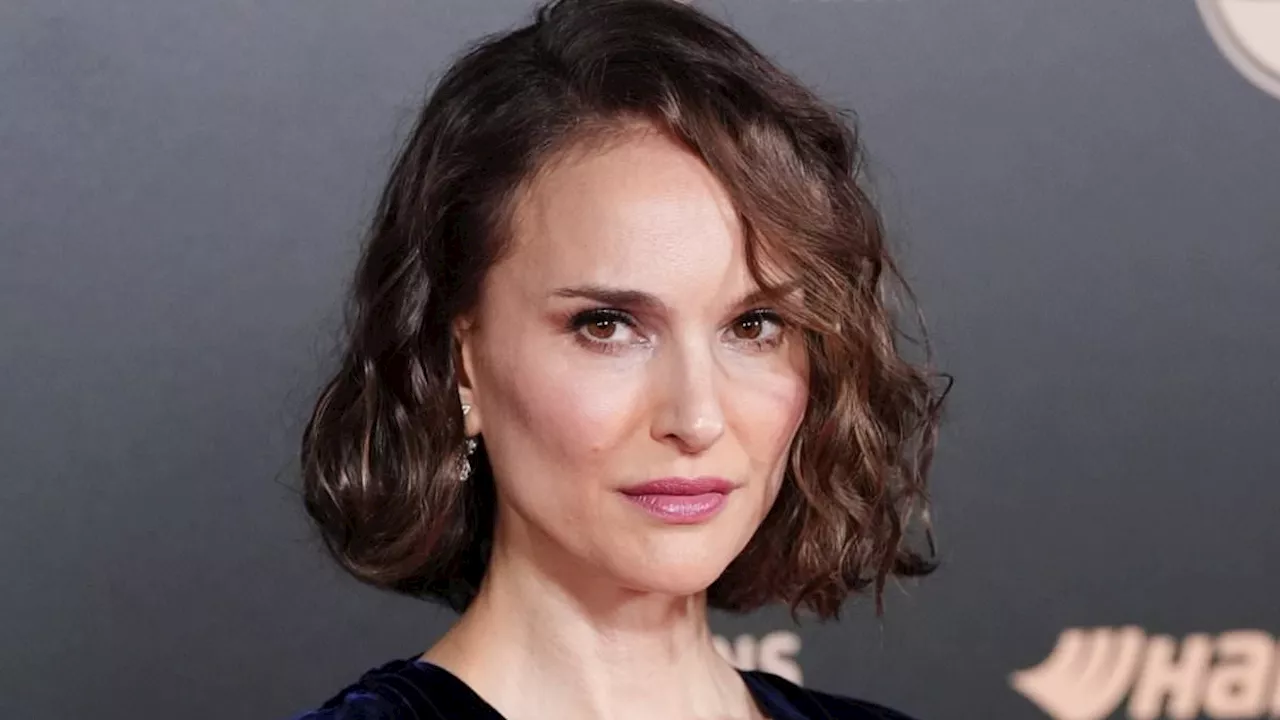 Natalie Portman turns heads in a plunging navy velvet gown as she joins the stars of the footballing...