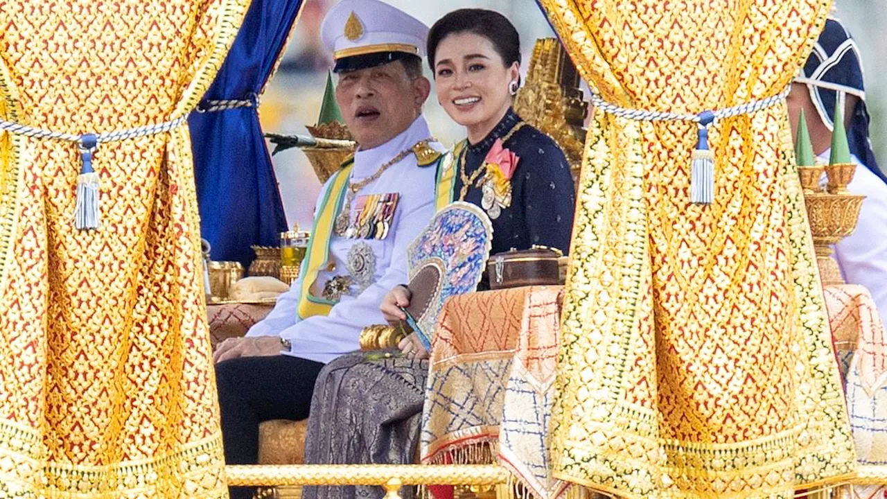 Thailand's Playboy King celebrates his 72nd birthday with a ride in a glittering royal barge...