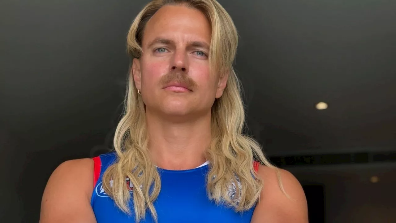 Courtney Act makes epic transformation into AFL superstar for Halloween